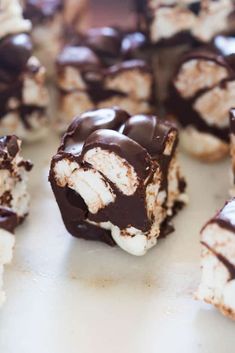 several pieces of chocolate and marshmallows are arranged on a counter top together