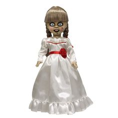 a doll that is wearing a white dress with red roses on the chest and eyes