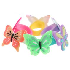 four bracelets with different colored butterflies on them