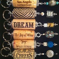 wine cork keychains are arranged in a row on a black background with the words dream, the joy of wine and others