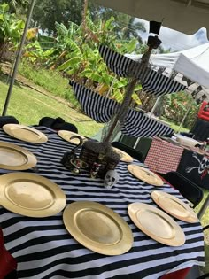 the table is set with plates and place settings