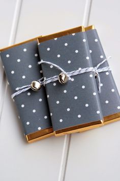 two gray and white dotted notebooks tied with twine