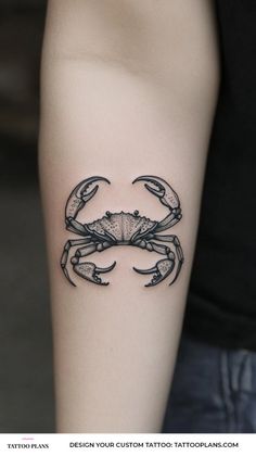 a black crab tattoo on the arm