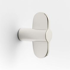 a white door handle on a white wall