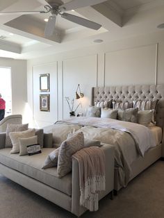 a large bed sitting in the middle of a living room next to a couch and chair