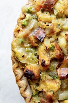 a close up of a pie with broccoli and other toppings on it