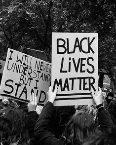 black lives matter protestors holding up signs