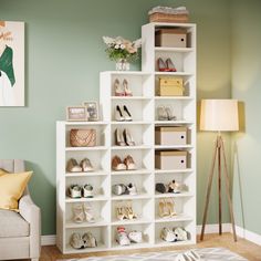 a living room filled with lots of white furniture and shoes on top of bookshelves