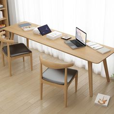 a laptop computer sitting on top of a wooden desk next to a book shelf filled with books