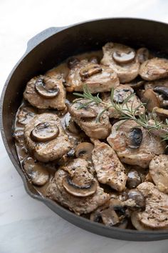 a skillet filled with mushrooms and herbs