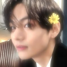 a man with a flower in his hair