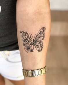 a woman's arm with a butterfly and flowers tattoo on the left side of her arm