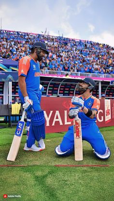 two men in blue and orange uniforms playing cricket