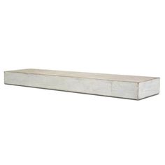 a white wooden shelf sitting on top of a wall