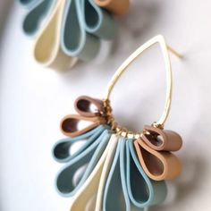 two pairs of earrings with different colors and shapes on the earring hooks are shown