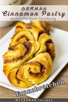 some cinnamon rolls on a white plate with coffee in the background and text overlay that reads german pastry specialty from hamburg