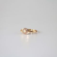 This unique Evil Eye ring features a round opal stone surrounded by a halo of clear cubic zirconia stones, all set on a gold plated band. The opal stone at the center of the ring glows with a soft iridescent light, adding a touch of magic to the overall design. The ring is delicate and dainty, yet eye-catching due to its unique shape and design. It would make a great gift for someone who loves opals or unique jewelry pieces. 10k gold plated sterling silver base Adjustable US size 6-8 Jewelry car Celestial Yellow Gold Opal Ring, Celestial 14k Gold Opal Ring, Adjustable Gold Opal Ring, Handmade Spiritual Open Opal Ring, Gold Opal Ring As Gift, Oval Cabochon, Iridescent Light, Personalized Gift Cards, Evil Eye Ring, Eye Ring