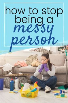 a woman sitting on the floor in front of a couch with cleaning supplies around her