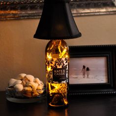 a lamp that is on top of a table next to some cookies and a bottle