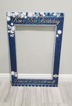 a blue frame with white flowers and the words, mom's 3rd birthday written on it