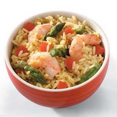 a red bowl filled with rice and shrimp