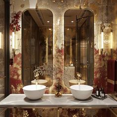 two white bowls sitting on top of a counter in front of large mirrors with gold trim