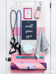 a pegboard with some items on it and a sign that says small space gym