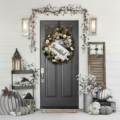 a front door decorated with wreaths and decorations