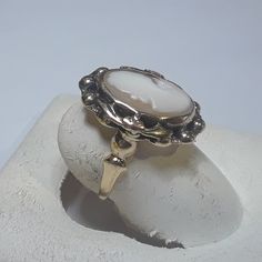 a white ring sitting on top of a rock