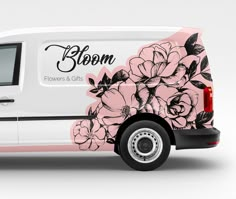 a white van with pink flowers painted on it's side and the word bloom written in black