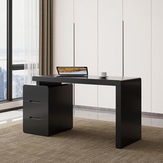 an office desk with a laptop on it in front of a window overlooking the city