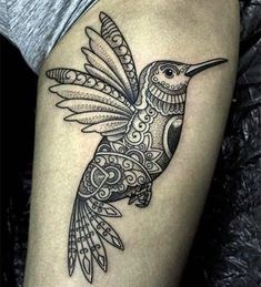 a black and white tattoo with a bird on it's arm, in the shape of a flower