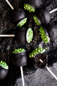 chocolate covered marshmallows and green candies on sticks