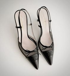 a pair of black high heeled shoes with bows