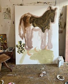 a horse is standing in the middle of an art studio