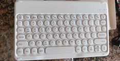 a computer keyboard sitting on top of a table next to a mouse and headphones