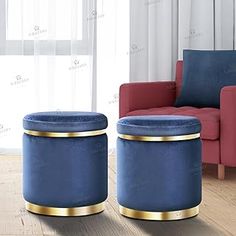 two blue stools sitting next to each other in front of a red couch and chair