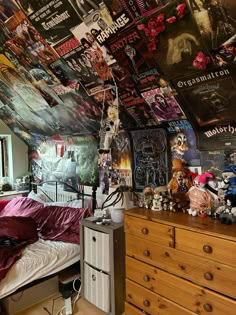 a bed room with a neatly made bed and lots of posters on the wall