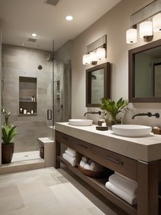 a large bathroom with two sinks and a shower stall in the middle, surrounded by white towels