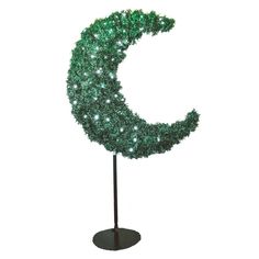 a green lighted crescent on a black stand