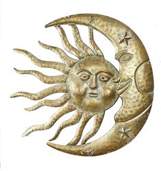 a metal sun and moon wall hanging on a white background with stars in the sky