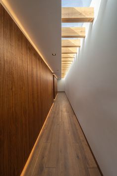 the hallway is lined with wood and white walls