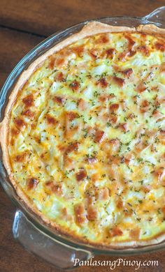 a cheese pizza sitting on top of a wooden table