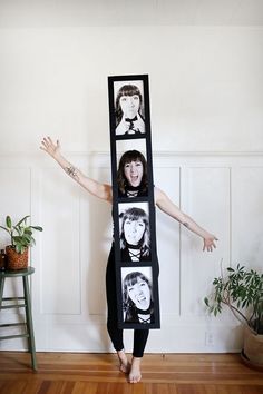 a woman standing in front of a mirror with pictures on it's face and arms