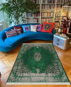 a living room with a couch, rug and bookshelf full of books in it