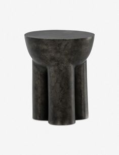 a black table with three legs and a round base on it's side, against a white background