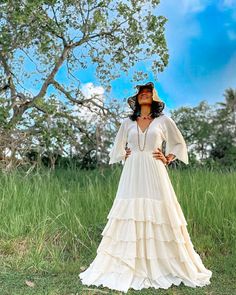 Bohemian V-neck Maxi Dress For Beach Wedding, Bohemian Tiered Beach Dresses, Elegant Flowy Boho Dress For Festivals, Bohemian Tiered Cream Maxi Dress, Bohemian Cream Tiered Maxi Dress, White Floor-length Dress For Festival, Elegant Flowy Maxi Dress For Festivals, Flowy V-neck Dress For Beach Wedding, Flowy Tiered Cream Maxi Dress