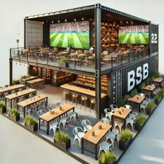 an outdoor bar with tables and chairs in front of a soccer field on the wall