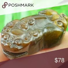 a hand holding a small carved animal on it's finger with the price tag $ 78