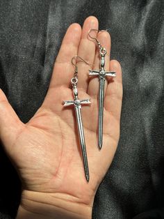 SWORD,  silver, big, large, oversized, statement, earrings. Great dangle, drop, hanging, earrings with hook.    Great to give as a gift or to add to your own earring collection.  The hook for the earrings is made out of stainless steel. The sword is made out of metal. Style: 90s, grunge, goth, gothic, minimalist, alternative, rocker, biker, joan of arc, motorcycle, etc.. measurements: drop: 4"L body of sword: 3 1/4" L Gothic Minimalist, Earrings Goth, Earrings Cool, Jeanne D'arc, Cool Swords, Joan Of Arc, Earring Collection, Le Crochet, Grunge Goth